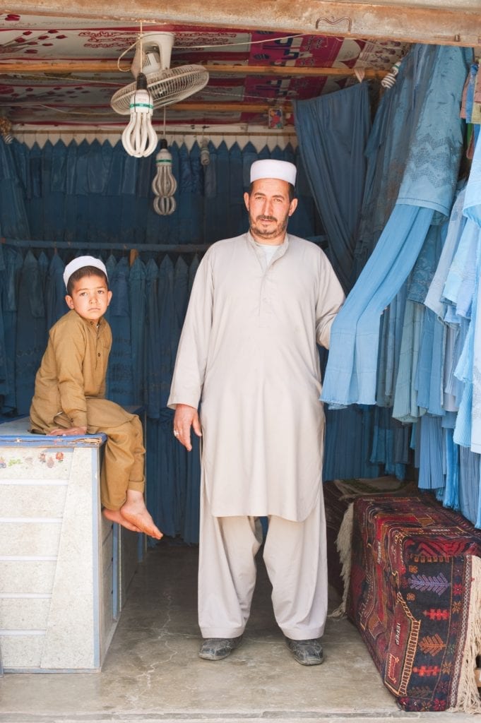 Burqa seller Herat Afghanistan by Simon Urwin