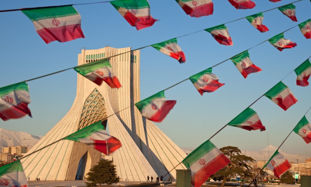 This image has an empty alt attribute; its file name is Azadi-monument-and-small-Iran-flags-1024x618.jpg