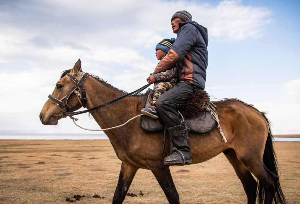 Child riding horse Kyrgyzstan by Bharat Patel