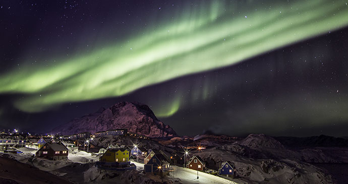 The northern lights shine over a small town in Greenland 