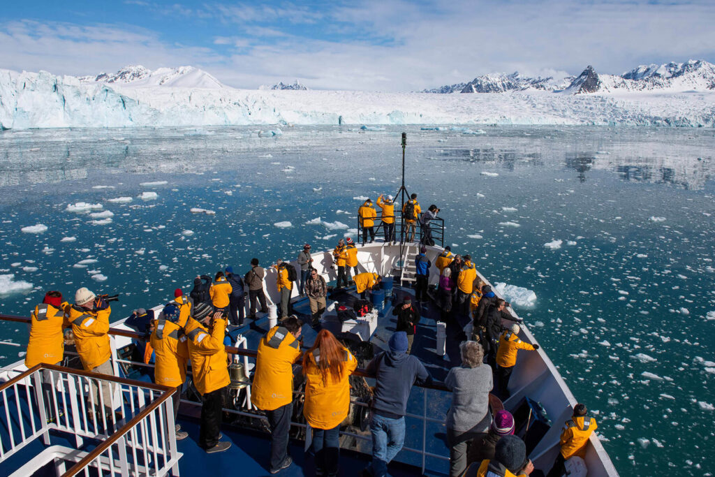 A boat sails through the icy waters of Svalbard. 