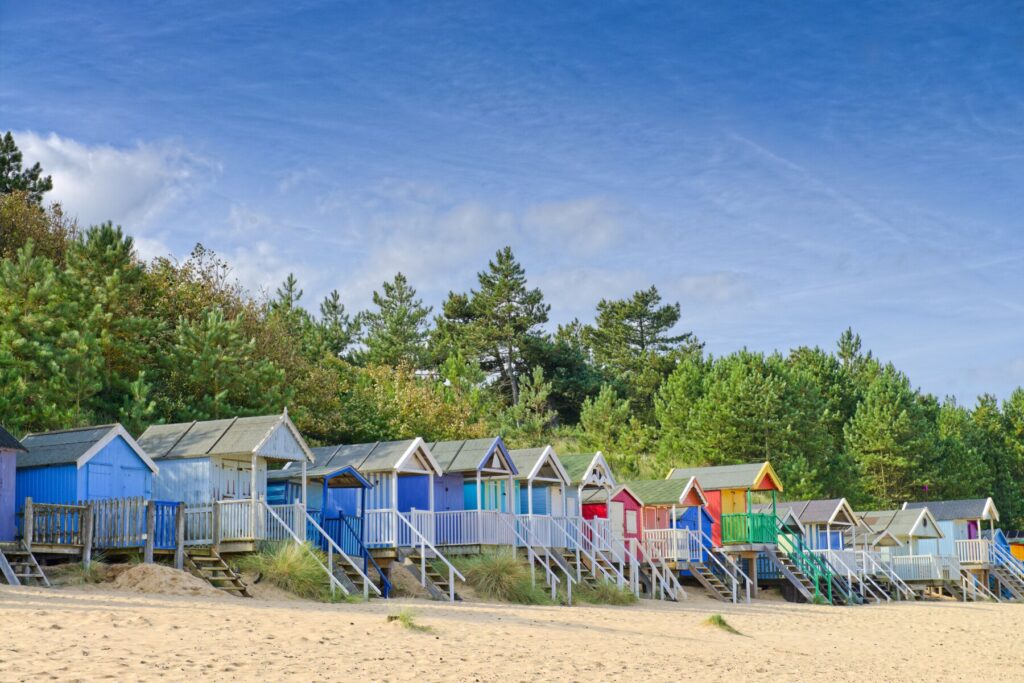 Colourful huts sits on Holkham Beach in Norfolk 