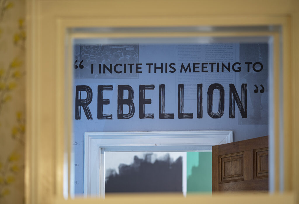 A sign located in Manchester's Pankhurst Centre reads 'incite this meeting to rebellion.' 