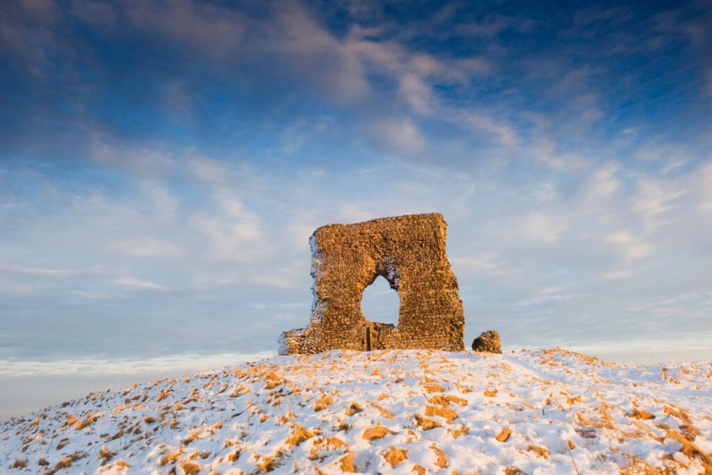 The ruins of Dunnideer Castle (Scotland) in the snow 