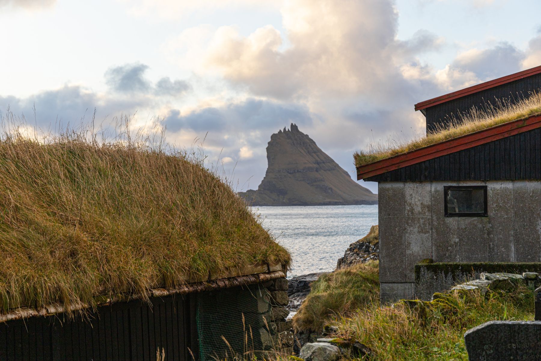 Peak seen between houses in the Faroe Islands.