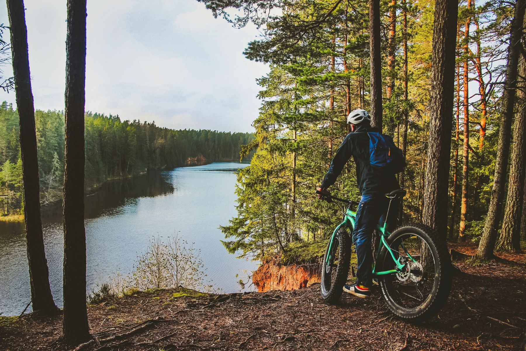 A cyclist on a fatbike looking out over a lake in Estonia