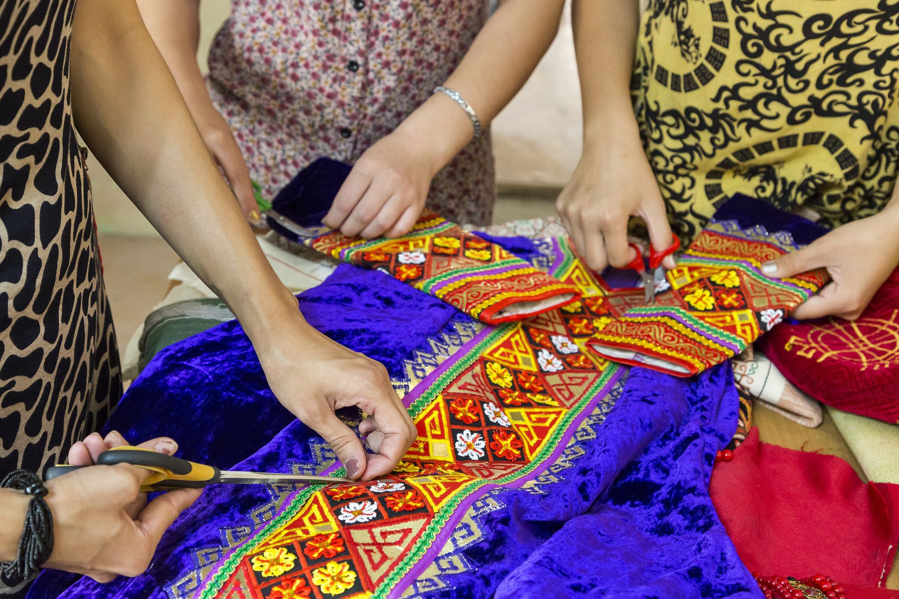 Tailors making a wedding dress in traditional Karakalpakstan patterns
