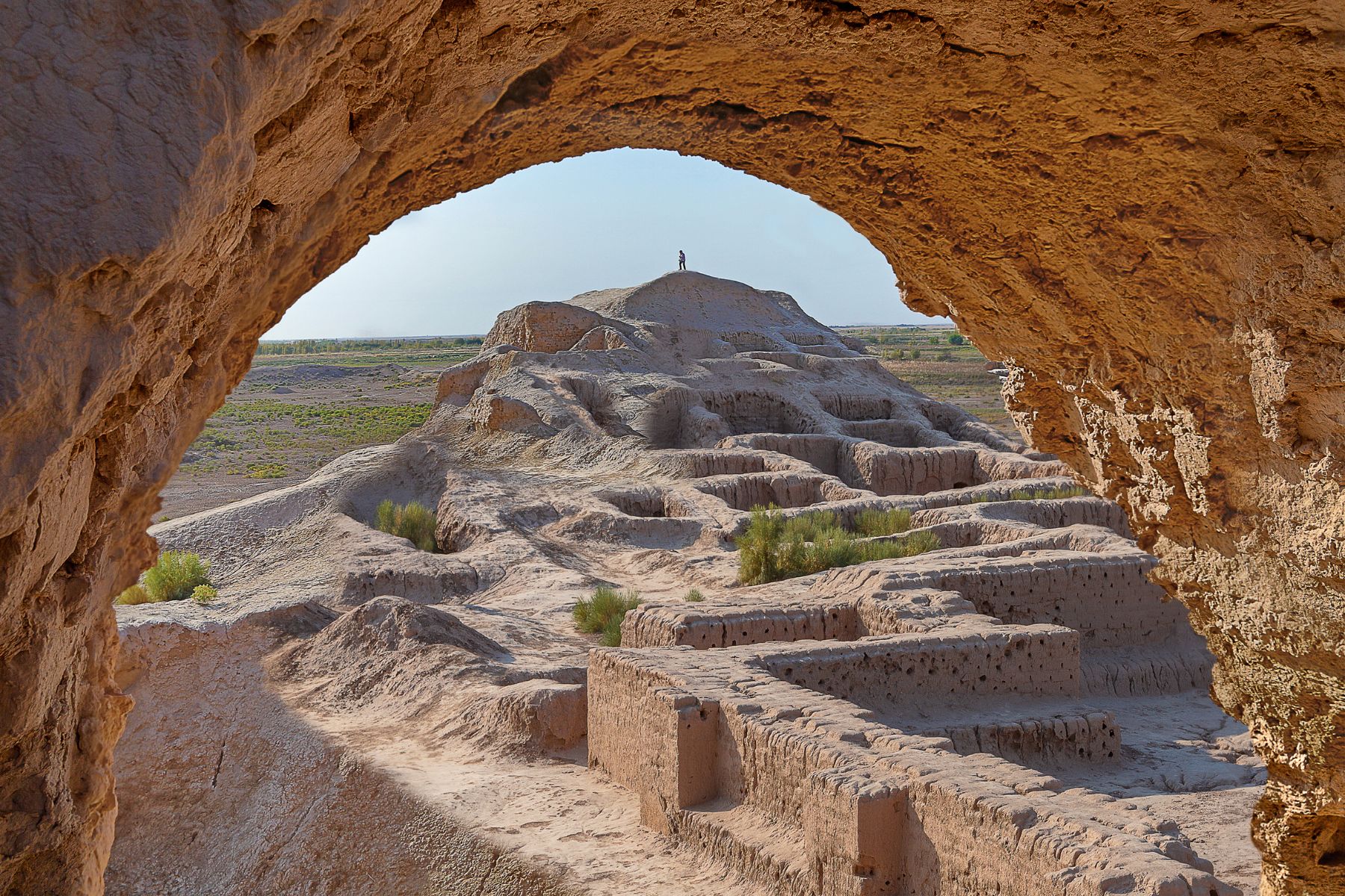 Ruins of the Toprak Kala fortress seen through an arch in Khorezm, Karakalpakstan