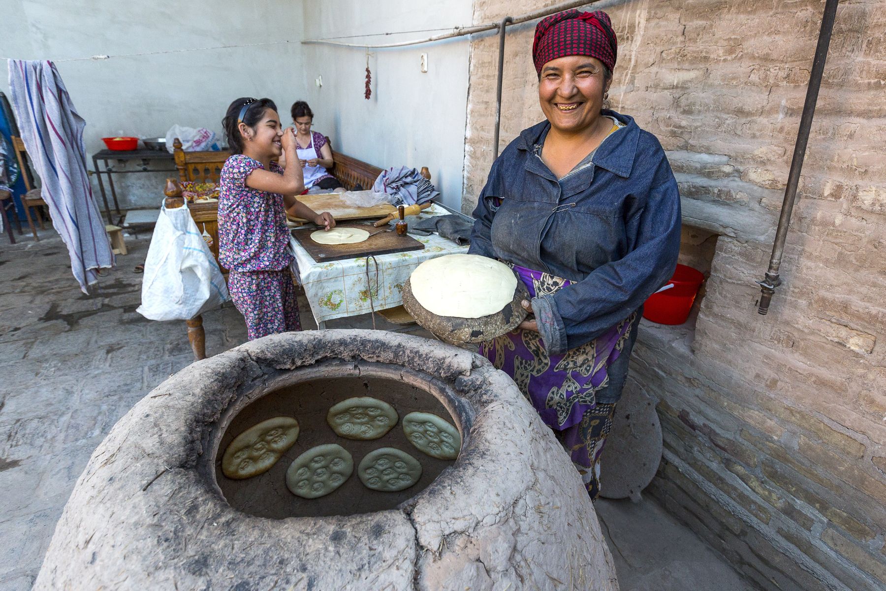 A traditional tandoori oven being. used to bake bread in Khiva, Uzbekistan