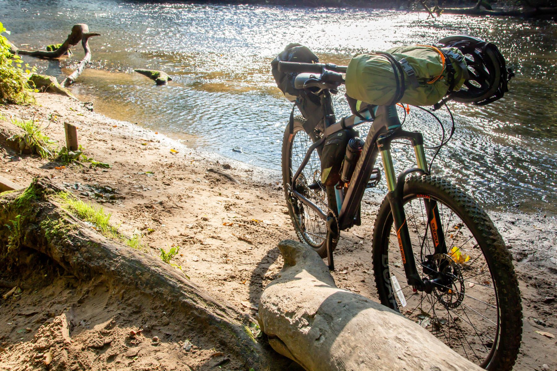 A bike set up for bikepacking by a river in Cheshire, United Kingdom