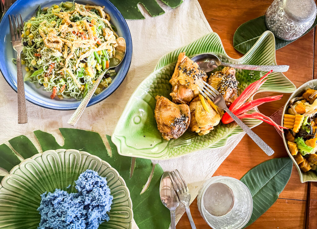 Platter of food including chicken and indigo rice in Phrae Thailand