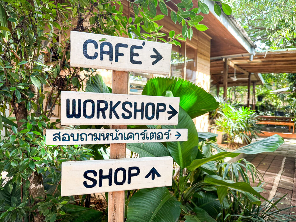 Signposts leading to an indigo workshop to revive traditional crafts in Phrae