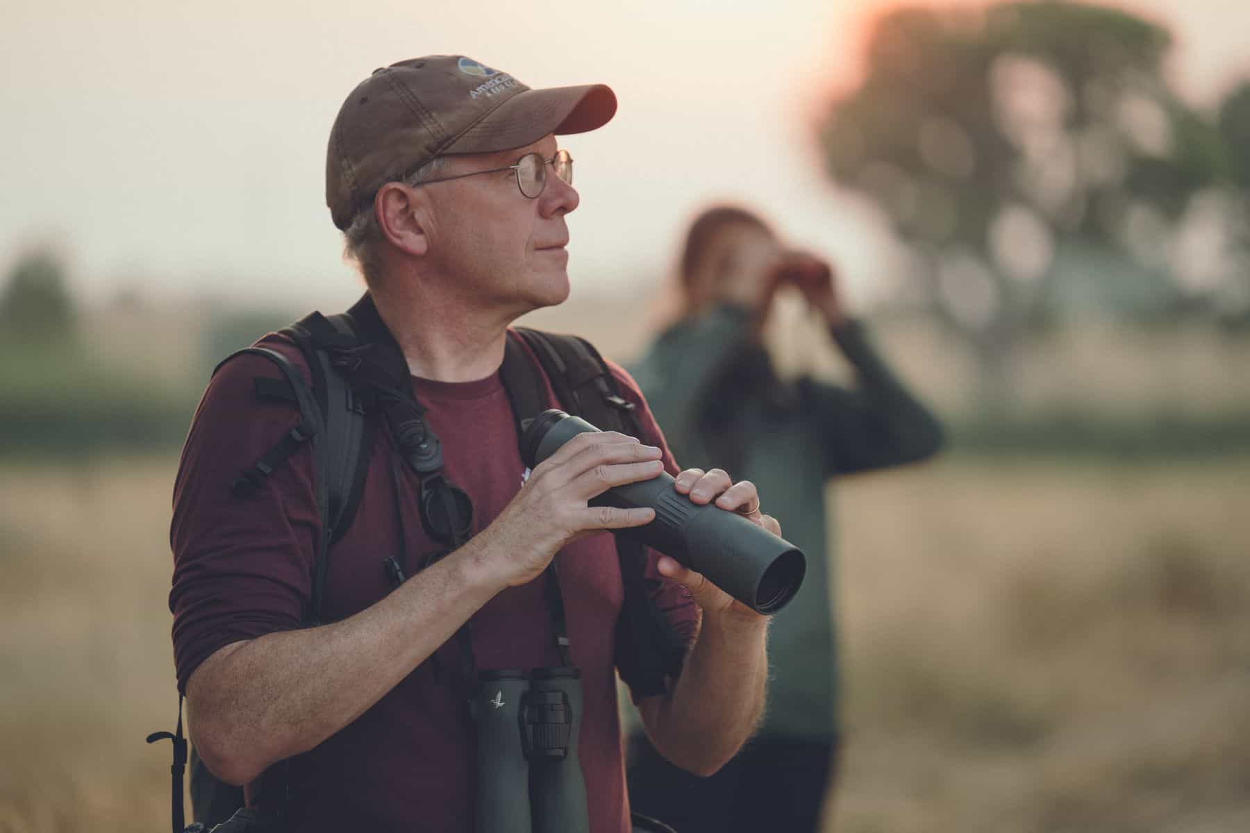 A man holding a scope among nature