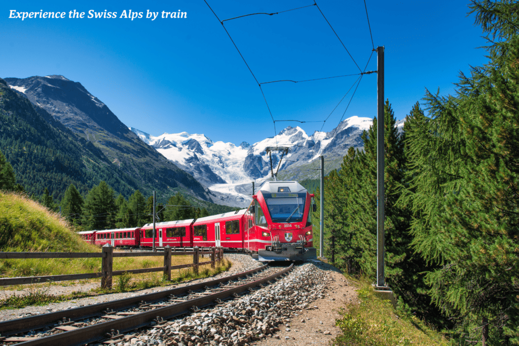 Red train travels through the Alps in Switzerland 
