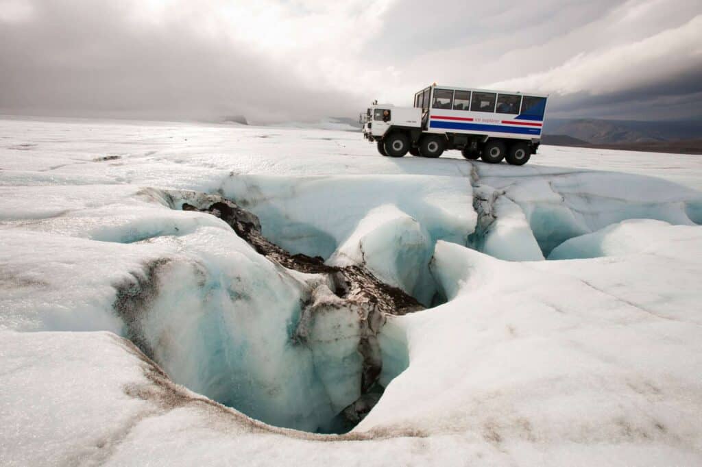 Truck of tourists at the ice cave on Langjokull glacier, Iceland