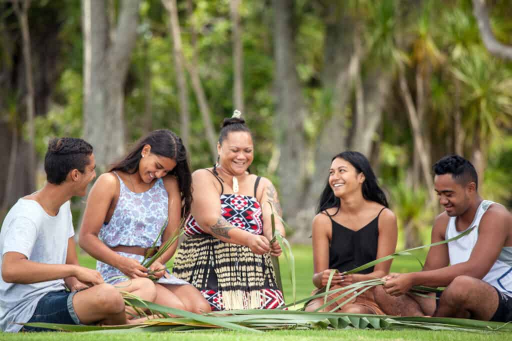 Group of people flax weaving at Waitangi Treaty Grounds in New Zealand