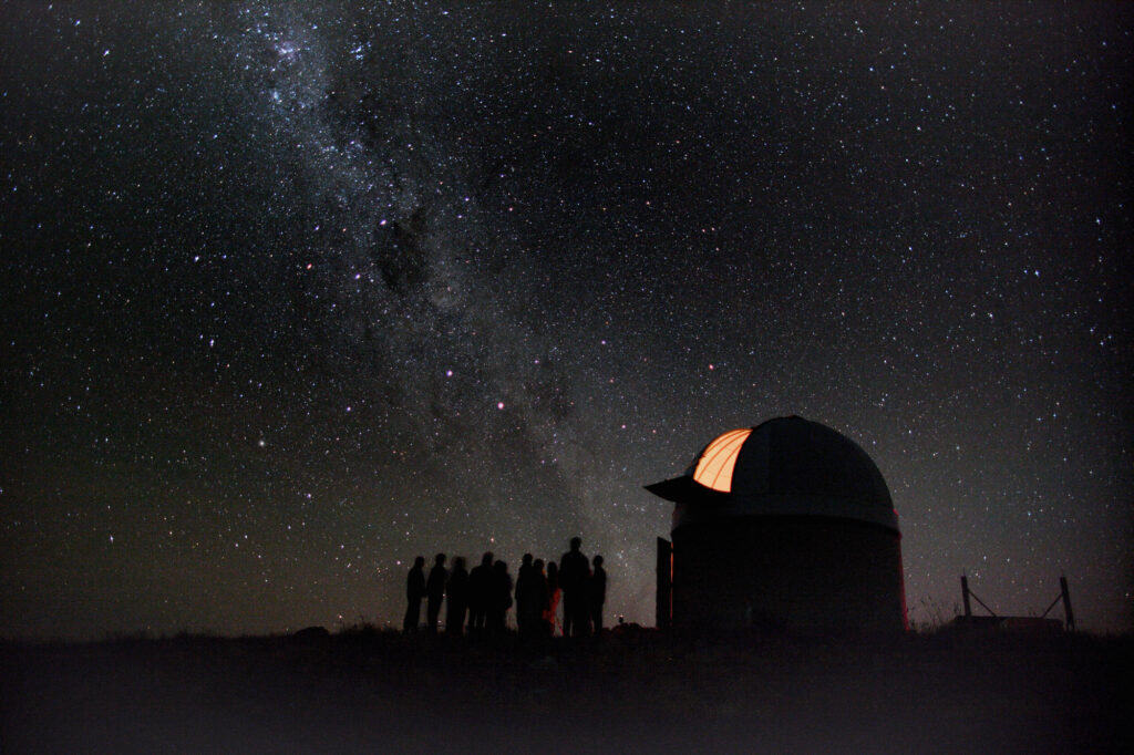 Group of people gather to stargaze in New Zealand. 