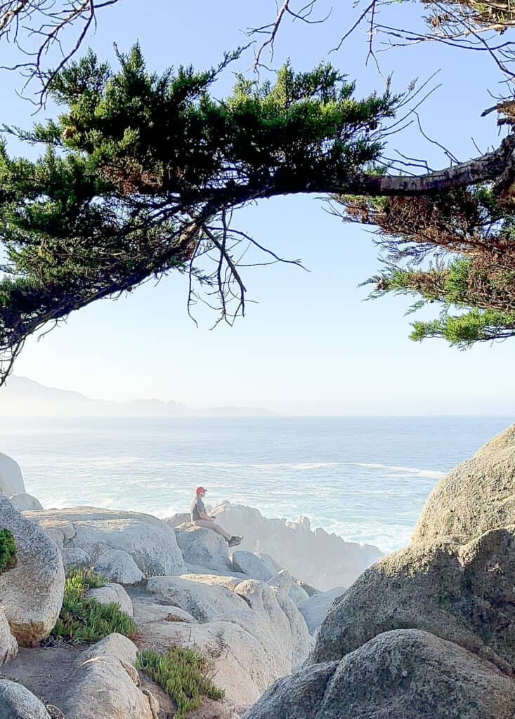 Man sitting at Pescadero Point on 17 mile drive