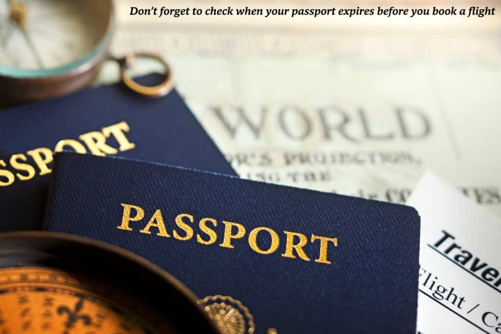 Two passports sit atop an old fashioned world map