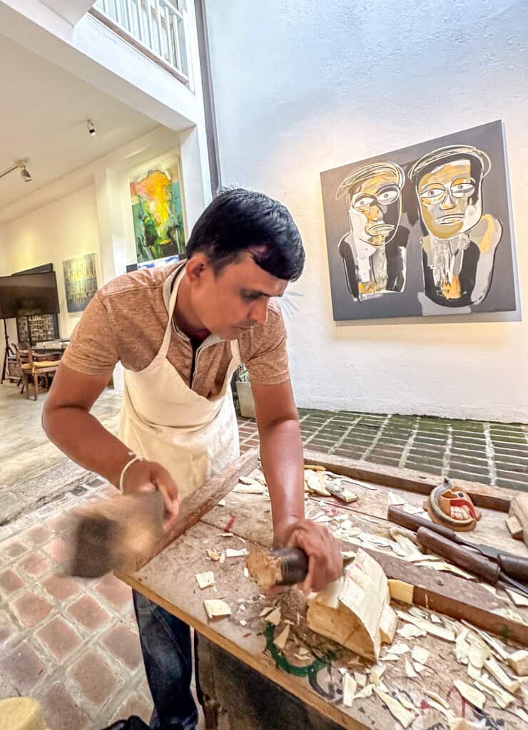 Man chopping wood at a mask making workshop in Sri Lanka - Sri Lanka's traditional masks 