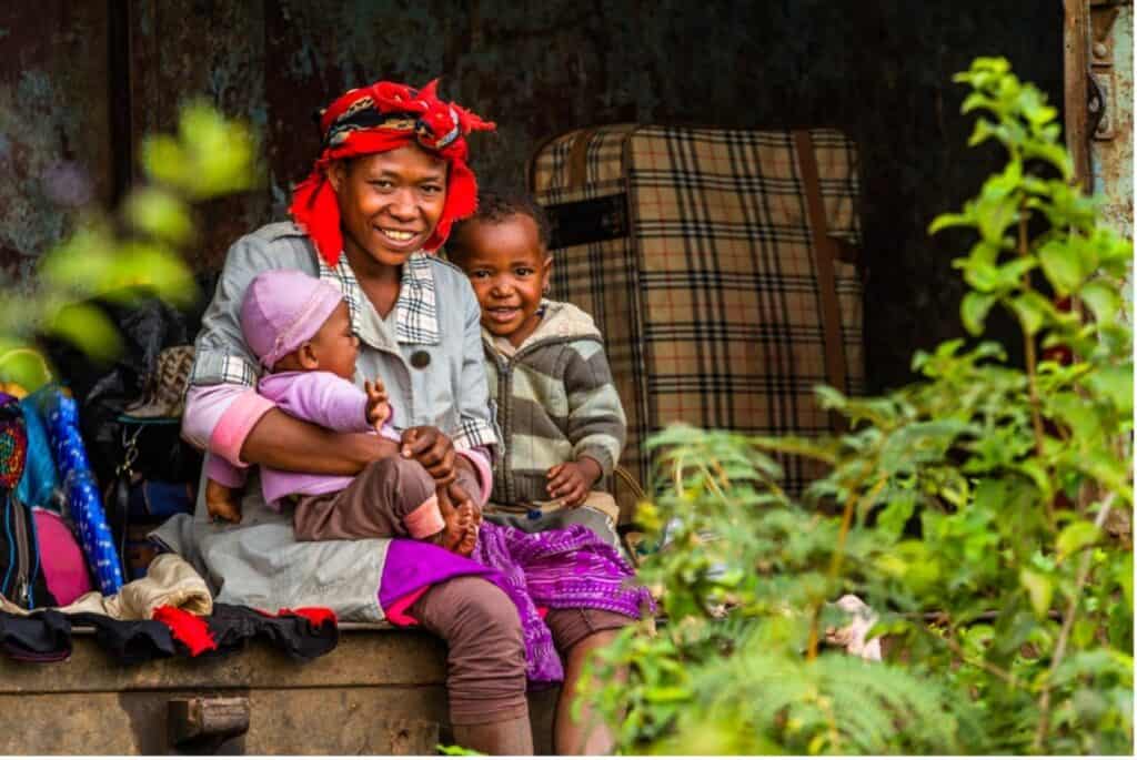 family of three smiling in Madagascar - interesting facts about Madagascar