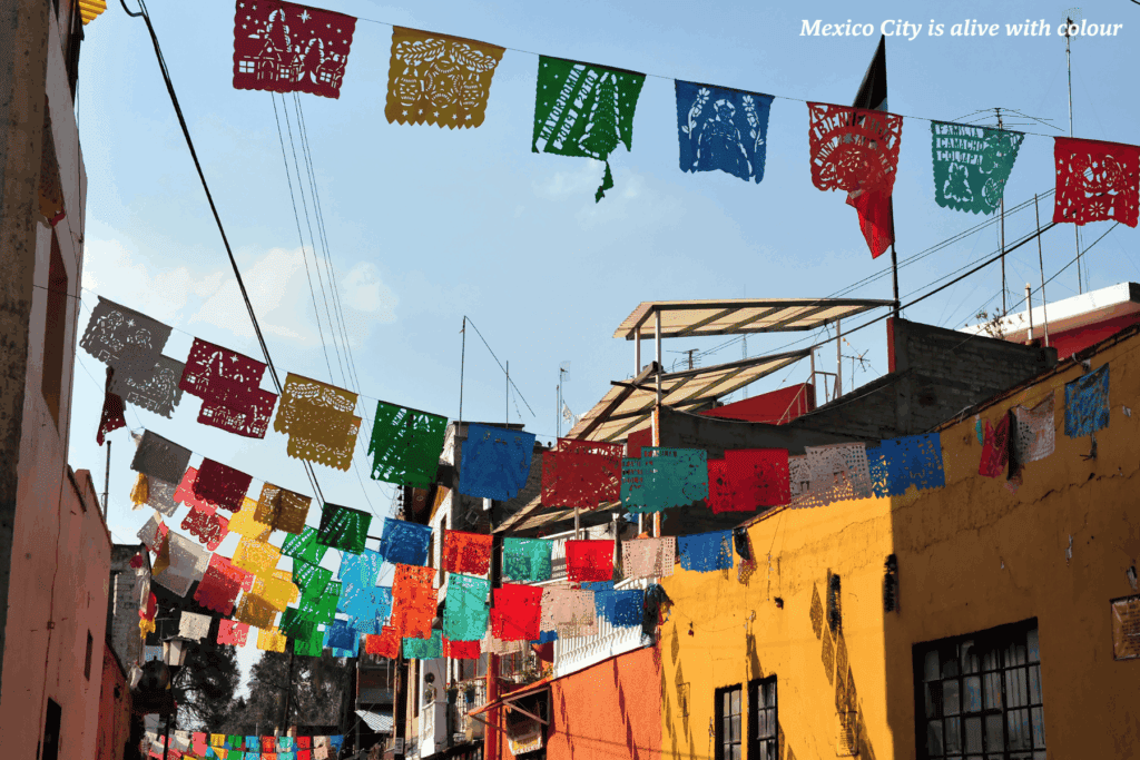 Flags hanging in a back street in Mexico City -  the best places to go in Latin America 