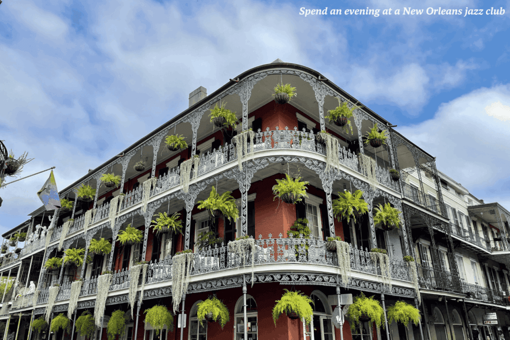 Plant covered traditional building on Bourbon Street in New Orleans - best train rides in the USA