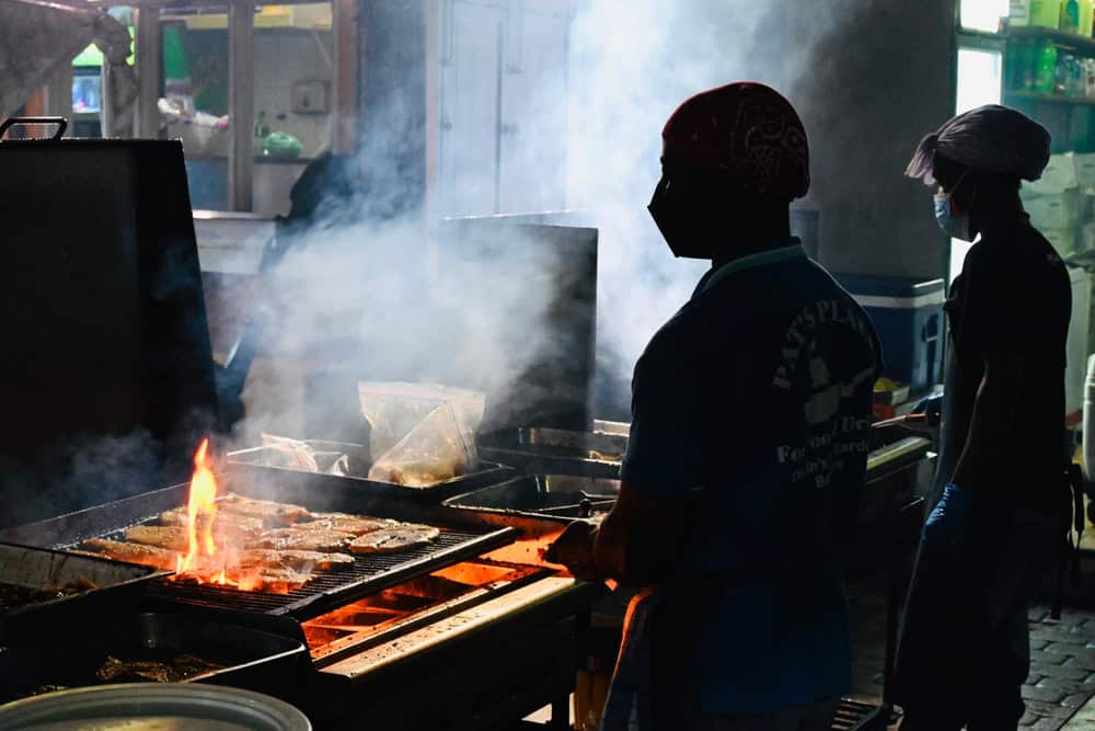 Fish cooking on the bbq at Oistins Fish Fry. -things to do in Barbados