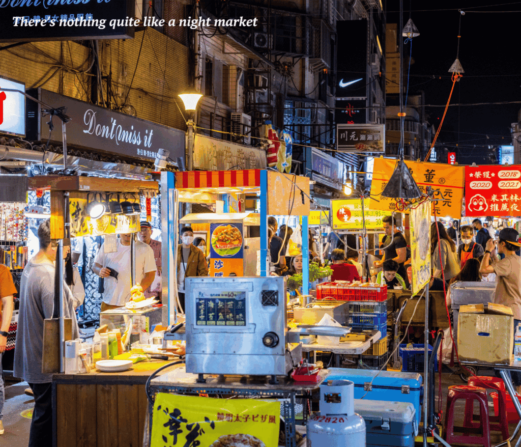 Vendors selling street food at Raohe Night Market in Taipei, Taiwan