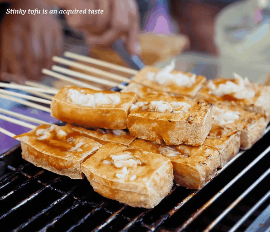 Skewers of stinky tofu on a grill in Taiwan