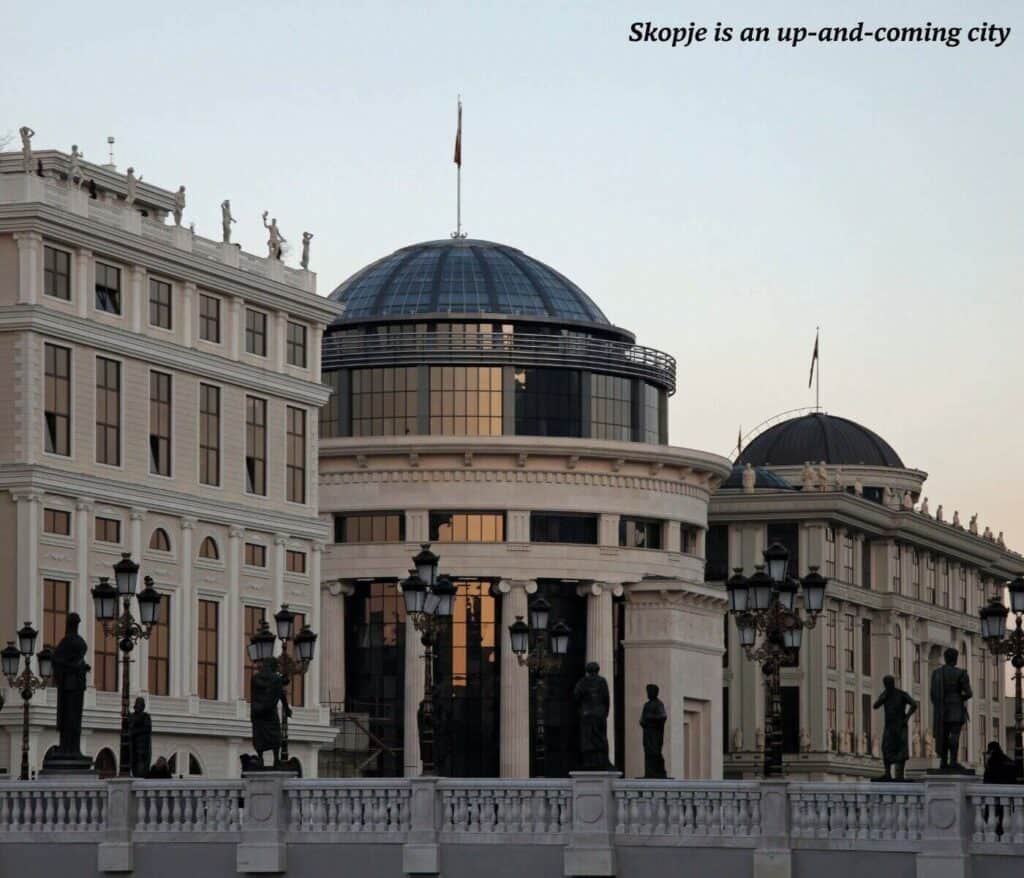 Buildings by the river in Skopje catching the light of the sun on their windows