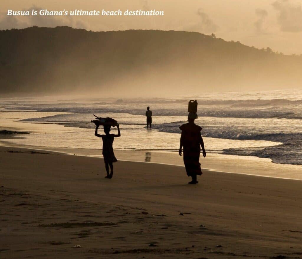 Women walking along the beach in Busua at sunset, Ghana
