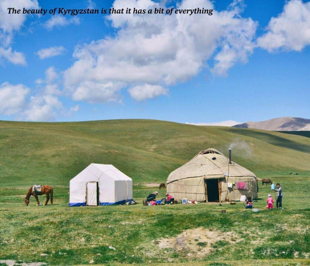 Horses and a nomadic family outside of a yurt in rural Kyrgyzstan