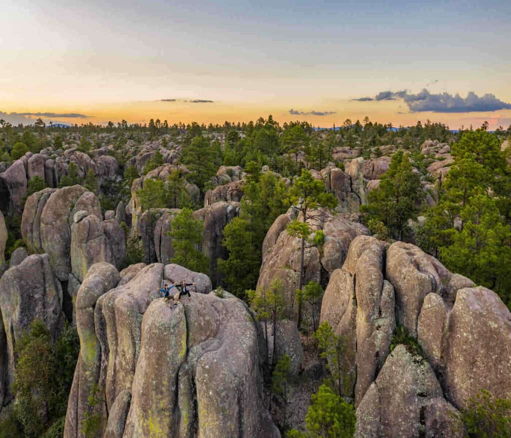 Two people sitting on a rock in the Valley of the Monks in Chihuahua State, Mexico