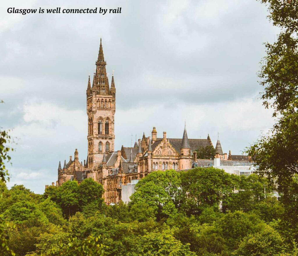 Spire of Glasgow University poking out above the trees in Scotland