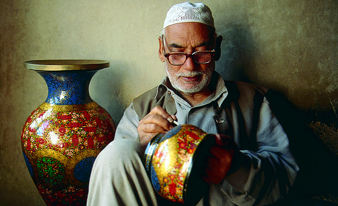 An artisan painting pots, Kashmir, India by J&K Tourism