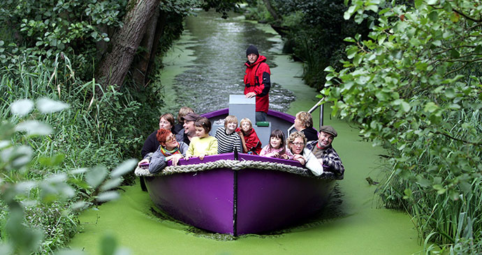 A boat sails down an artificial river at BeWILDerwood theme park in Norfolk 
