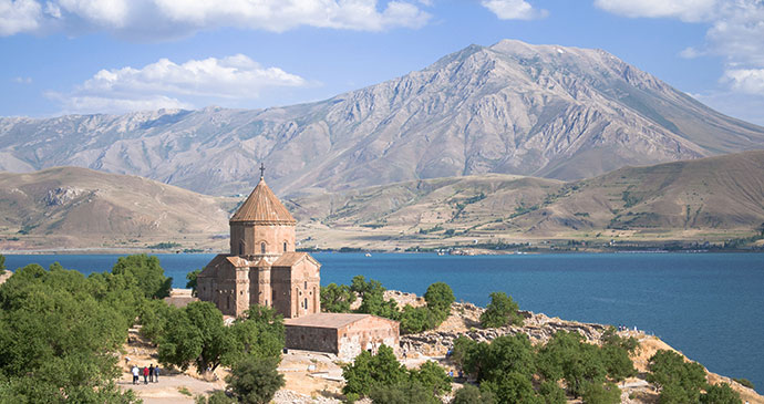 Armenian Cathedral Church of the Holy Cross on akdamar island with mountains in eastern turkey by murat karsli