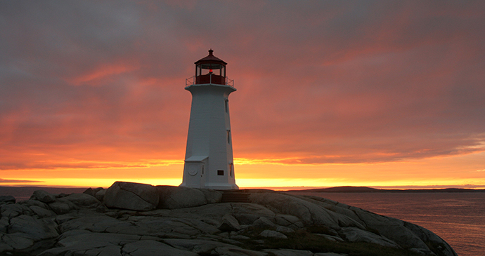 Lighthouse at sunset Peggys Cove Nova Scotia Canada by goofyfoottaka Shutterstock