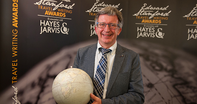 Alan Packer, winner of the Bradt New Travel Writer of the Year Award at the Edward Stanford Travel Writing Competition, with his antique globe trophy.